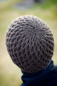 This pattern originally appeared in the Fall 2007 issue of Interweave Knits magazine. The design was inspired by the work of Dutch architect Rem Koolhaas. His geometric, structural patterns at the Seattle Public Library informed the cabled lattice motif encircling the beanie. Designer: Jared Flood Collection: BT Classi