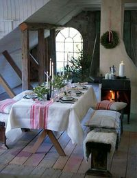 Simple red and white grainsack fabric set the tone for this Scandinavian style farmhouse Christmas tablescape.