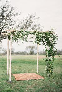 Brides.com: 55 Amazing Ceremony Structures A whimsical pink-and-white backdrop with draped fabric streamers and candlelit aisle, created by Beth Helmstetter Events. Photo: Steve Steinhardt