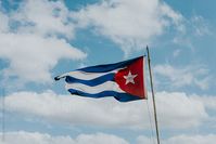 Cuban flag against the sky by Natasa Kukic for Stocksy United