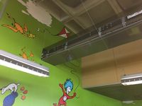 Lyngsoe conveyor runs through ceiling of children's area and into workroom. San Diego (City) Library