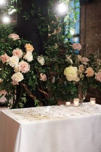 Right This Way Escort cards were displayed on a table decorated in florals.