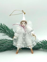 This souvenir is completely handmade and unique. The souvenir is made of porcelain (face, legs) and fabric. Made in St.Petersburg, Russia Size (height) -19cm (7,4 in).