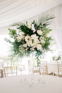 Leaf + Petal NOLA created gorgeous tall centerpieces of neutral garden florals with lilies, hydrangeas, garden roses, majolica, and lush tropical greens for a New Orleans wedding at Old Ursuline Convent.