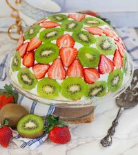 The most delicious and fluffy trifle cake recipe! This domed cake is made with strawberry, kiwi, fluffy whipped cream, sponge cake and creamy custard!