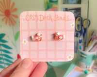 Hand sculpted polymer clay ducks wearing floral knitted jumpers to keep cosy this winter ! on 925 sterling silver posts and butterfly clasp backs , these miniature earring studs are the perfect dainty piece to your winter outfit