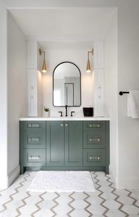 Forest green vanity and statement brass pendants bring drama to this bathroom. #brassdecor #green #diy #bathroom
