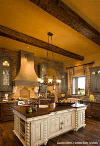 The creamy island, green upper cabinets, distressed wood beams. Yes.