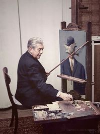 René Magritte at work in his living room, 1964.