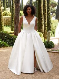Classic and dramatic satin, ballgown, plus-size/curvy wedding dress with pleated skirt, plunging V neckline and side slit. #MissRubyBride Available to try on in store in size 24