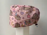 This is a handmade scrub cap perfect for use for all healthcare workers and patients who would like to cover their head with a cute pink Pusheen print scrub cap! It is made with an adjustable cord lock and is easy to put on and take off (great for when you’re rushing into a theatre case and don’t have time to tie on a single use cap)! This cap is able fit all head sizes and a varying amount of hair! Durable and handsewn with extra care. The insides are overlocked to prevent fraying. Please not