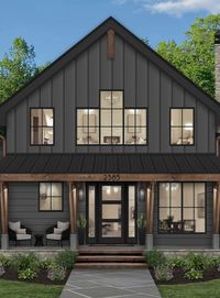 We love how we able to take a blueprint construction and turn it into this beautiful design! this home Looks AMAZING with the rich darker color palette and beautiful natural elements for textural contrast! We wanted this house to feel warm, inviting and convey the Lake house chic vibe. We added character to this home to aesthetically balance between the elements on the front.We added simple landscape to this home with new flagstone steps and pavers that lead to the walkway and entry.