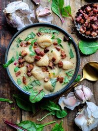 Fragrant thanks to roasted garlic, creamy thanks to white beans, and hearty thanks to gnocchi, greens and pancetta, this is comfort soup at its best! #soupseason #garlicsoup #roastedgarlicsoup #roastedgarlicgnocchisoup #comfortfood #budgetfriendlymeals #budgetfriendlyrecipes #glutenfree #feedingthefamily #whatsfordinner #soup #creamysoup #gnocchi #whitebeans