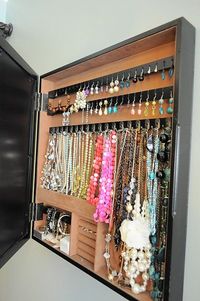 A jewelry box hidden behind a photo frame on hinges.