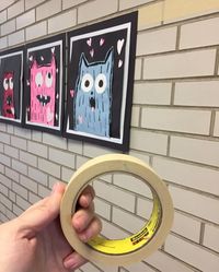 Art Teacher Hack: Line brick/cinder block walls with two rows of masking tape, and use hot glue to attach top corners of mounted art to the wall. Stays up as long as you need it to, and pops off easy when it's time to take it down. What a time saver! I can't believe I ever used to use tape loops! #ArtTeacherProblems #ProblemSolved