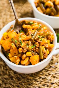 This Hamburger Goulash Recipe is comfort food at it's finest. Made with ground beef, elbow macaroni, tomato sauce, green beans, potatoes, corn and spices this weeknight meal is easy to make and is a dish the whole family will love!