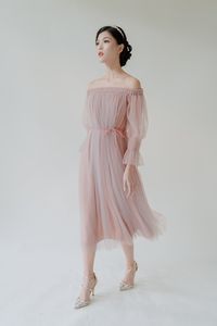 Rency Dress – Simply not your average tulle dress. An ethereal off-shoulder dress with sheer long sleeves in favourite tea-length that is accented by self-tie string bow for slimmer silhouette.