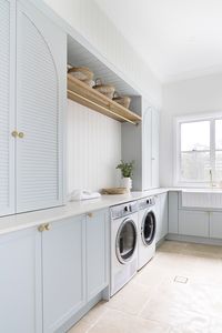 A new build in the charming Brookfield area of Brisbane, this home melds the best of country interior design with coastal and luxe influences. Gorgeous classic home that screams for a holiday asap! Laundry room styling: blue laundry, side by side washer and dryer, hanging rack, farmhouse sink, butlers sink, gold tapware, luxe laundry, gorgeous laundry, beautiful laundry, timber storage, basket storage, big window in the laundry. Check out more of this beautiful home by clicking the pin!