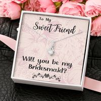 Make the moment special with our Bridesmaid Proposal necklace. This ALLURING BEAUTY necklace gift! The petite ribbon shaped pendant is finished with 14K white gold over stainless steel, and is embellished with dainty clear crystals surrounded by a sparkling 7mm round cut Cubic Zirconia. The adjustable cable chain allows the necklace to be worn at 18" to 22" in length. This necklace is one of our best sellers! Be sure to get yours NOW!