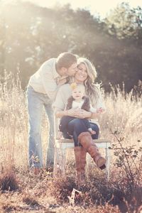 Family of three with 10 month old...daddy kissing mommy= happy baby!