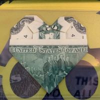 This is an origami heart with a bowtie on it (cute!) 💖 Note: Order early if you want to receive this by Valentine's Day 🗓️ It is real United States money and is delivered flat inside a stiff plastic currency holder 📦