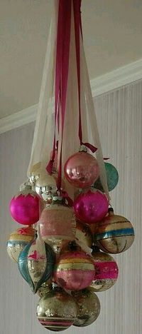 Vintage Christmas ornaments hung on ribbon to create chandelier