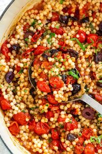 Israeli couscous with tomato and olives is a flavorful side dish that's tossed in a Mediterranean-inspired sweet and tangy cherry tomato sauce. #couscous #mediterranean #healthy