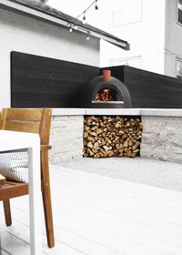 An urban Minnesota Modern backyard design, outfitted with two living spaces plus a kitchen area for a wood fired pizza oven.