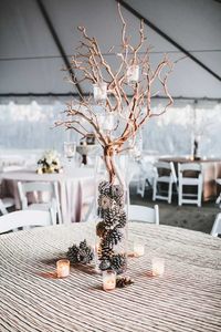 Pine cones and candles create an elegant winter wedding centerpiece.