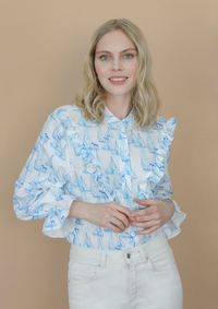 A classic button-down in our free spirit print with a feminine ruffle. The perfect shirt to wear with jeans and make any outfit special and equestrian. Fabric Description and Care: 100% Eco Rayon