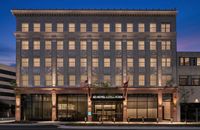 The AC Hotel Little Rock Downtown is set in the Beaux Arts-style Hall Davidson building from 1932 and an adjoining annex built in the 1950s. Both are on the National Register of Historic Places. Each of the clutter-free 114 guest rooms features an original photograph by Chris Cranford of details of the hotel before its renovation. The AC Lounge features artwork by Rayna A. Macky and furniture made in Dermott by the Paul Michael Co.