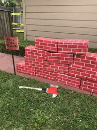 I got boxes of similar sizes at a grocery store in the meat/cheese department. Wrapped them in brick wrapping paper. And then wrapped them again in clear contact paper to help give a layer of protection against the “fireman ax”. The ax is made from a wooden hurling stick and the top ax part is made from card board and duct tape and then painted.