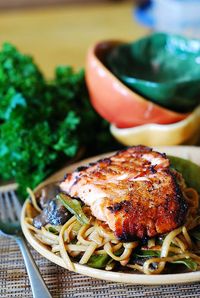 Asian honey-soy salmon and noodles with mushrooms, snow peas in