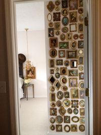 Entrance to master bedroom. Collection of small florentine frames.