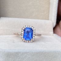 A beautiful Ceylon Blue Sapphire Halo Engagement Ring ,featuring a Radiant cut Blue sapphire with natural diamonds Set in 14K Rose Gold on hand made ring. Comes with certificate of authenticity. Main Stone: Blue Sapphire Color: Light Blue Cut : Radiant Cut Main Stone size: 2.22 carat (8.30 x6.03 x4.48mm) Clarity : VS Treatments :Traditional Heat only Cost USD : 1700