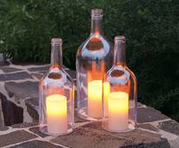 Cut the bottoms off wine bottles to use for candle covers! How cool looking- and keeps the wind from blowing them out!