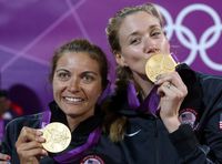 US volleyball players Missy May Treanor and Kerri Walsh Jennings show their gold medals some love