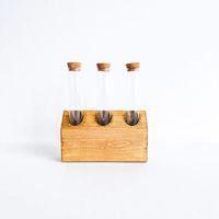 These handmade propagation stations can stand on their own and have keyhole cut outs in the back to be able to hang on your walls. Simply add water to the tubes and place plant cuttings or cut flowers. Stained natural pine Measures 6"W x 6.75"H Includes three glass test tubes with cork tops Handmade in Minneapolis, M