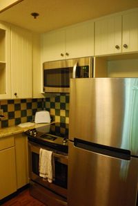 Villas at Wilderness Lodge Remodel - granite countertops, white cabinets, and stainless steel appliances.
