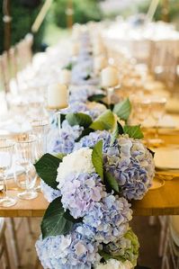 Only blue hydrangeas for the decoration of this wedding table! An elegant tableware and a touch of gold, so many candles, the perfect choice for this wedding table decoration. More details about this wedding in Provence, in the wonderful village of Lourmarin on our website : www.seabrideandsun.com #hydrangeaweddingdecoration #hortensias #blueweddingdecoration #eleganttabledecoration