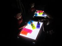 prism bricks and action figures on light table