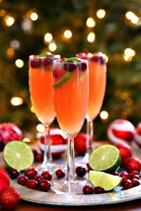 Celebrate the holidays with Christmas Mimosas! A fun twist on a traditional mimosa that's perfect for Christmas. Make Christmas Mimosas, Christmas Mimosa Punch, and Christmas mocktails with this easy recipe.