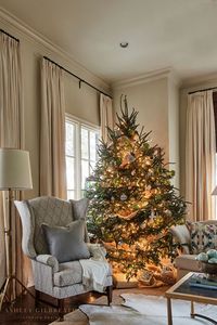 ASHLEY GILBREATH INTERIOR DESIGN: A cozy corner to cuddle up with a cup of hot chocolate this holiday season. We love sitting in a wingback chair next to a Christmas tree filled with all the lights, ornaments, and ribbon.