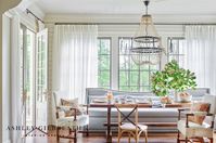 ASHLEY GILBREATH INTERIOR DESIGN: A family style breakfast nook. Designed to accommodate large groups, the breakfast room fea- tures a mix of seating options. The antique walnut table is from Belgium and the light fixture is by Noir. architect Brandon Ingram