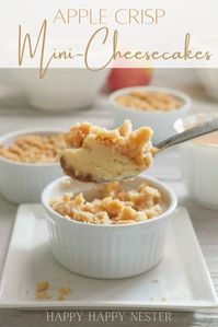 These Apple Crisp Mini Cheesecakes are the perfect blend of sweet apples, cinnamon crumbs, and cream cheese filling. These easy cheesecake desserts are baked in paper muffin liners or pretty porcelain ramekins.