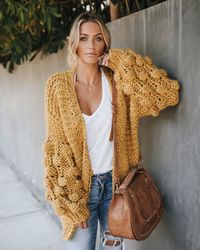 best seller 100% acrylic hand wash cold. dry flat open neckline honeycomb sleeves thick knit not lined each individual cardigan is handmade //best seller// this sweater was made with tlc for sure ¨c each one is made by hand! our tender loving care knit cardigan is on trend in this chunky weave that has an exaggerated honeycomb effect on the sleeves! the open neckline and relaxed wear of this layer makes it ultra comfortable and easy to throw on this fall. warm and cute as ever! styled with our w