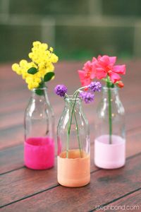 Cute idea. Mini milk bottles or juice bottle dip-dyed and used as bud vases.
