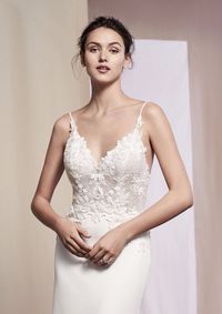 Look your best in this crepe slim gown. Intricate beading with Venice lace illusion bodice. Lace along the back hem finishes the dress.