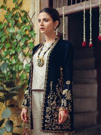 Pakistani Party Wear Organza Suits Online for Ladies is a contemporary Blue velvet jacket handcrafted using the finest techniques with gold enameled embroidery on the front and sleeves. It is paired with a screen-printed shirt and raw silk pants enhancing the details of the garment. Detailed Description: SKU: PN626 Detailing: Beads, Pearls, Embroidery, Sequins, Motifs Color: Blue Gold Fabric: Pure Silk Organza, Velvet Design: Fully Embellished Dress with Embroidery, Sequins, Motifs Event: Weddin