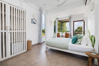 A white bedroom can work its charm even if pared back, housing only the bare essentials. Play with different materials such as cottons, silks and satins to create texture. Image courtesy, Mitch Fong for Ceylon Sliders